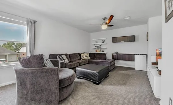 a living room with couches and a flat screen tv