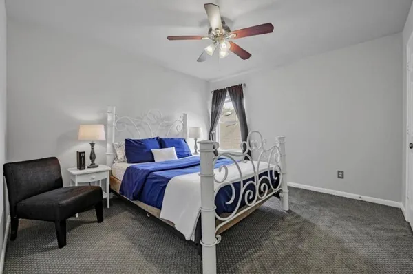 a bed room with a bed and a chair