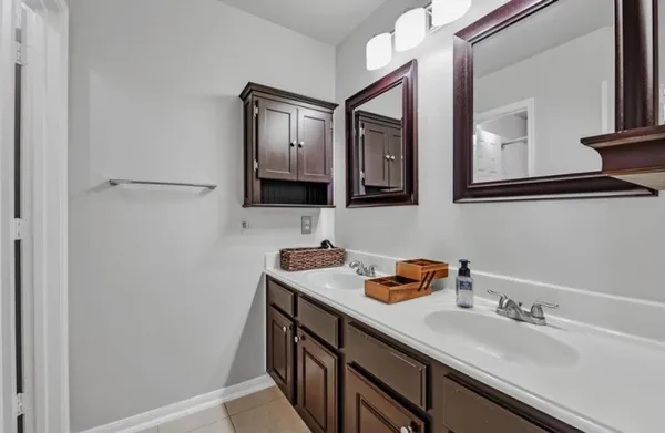 a bathroom with a sink vanity and mirror