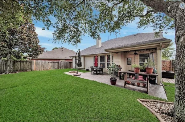 a view of a house with backyard and sitting area