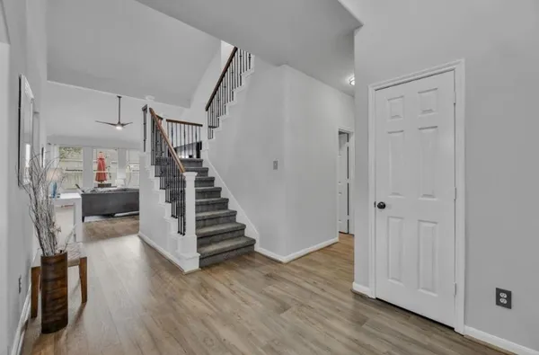 a view of entryway with wooden floor and stairs