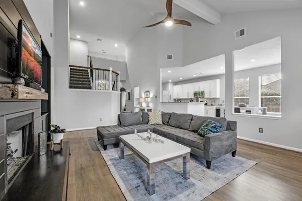 a living room with fireplace furniture and a flat screen tv