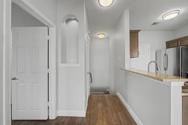 a view of a kitchen from the hallway