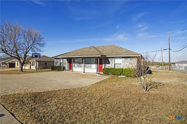 a front view of a house with a garden