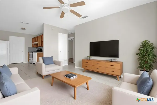 a living room with furniture and a flat screen tv