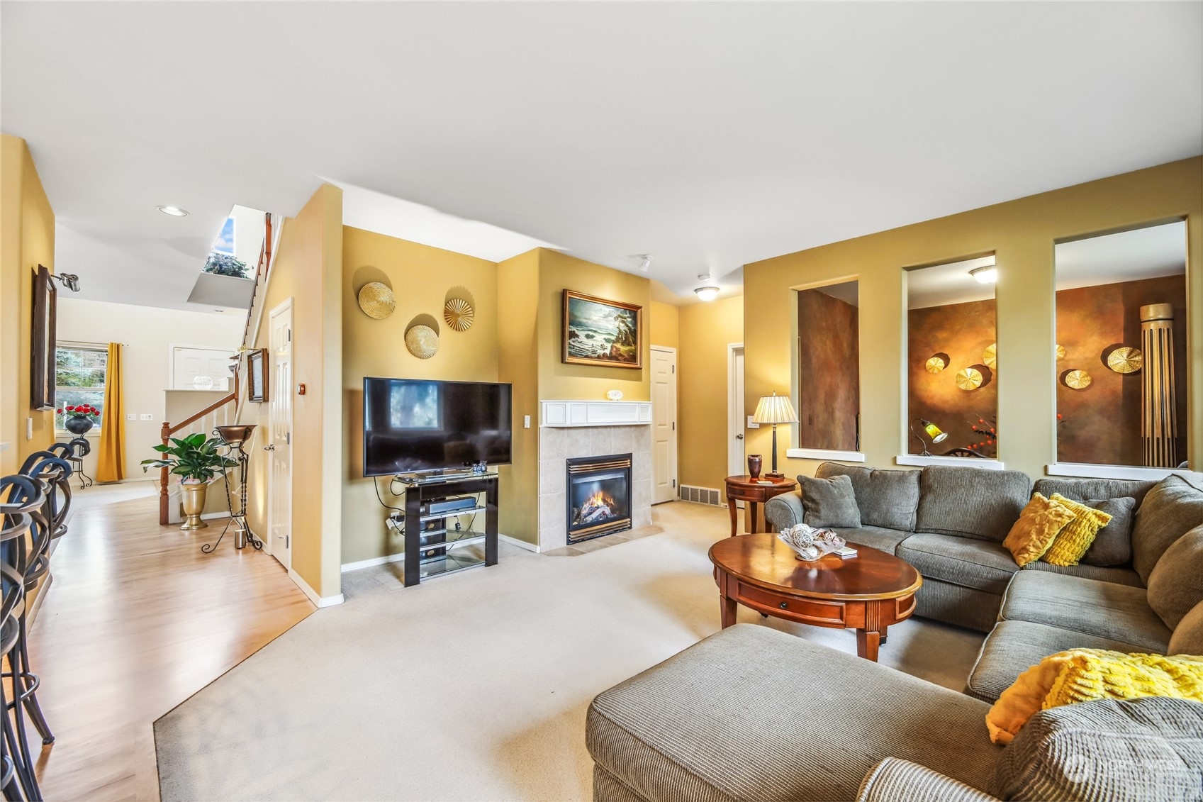 210 202nd Street Southeast Bothell, WA 98012 - Photo 8 of 33 a living room with fireplace furniture and a flat screen tv