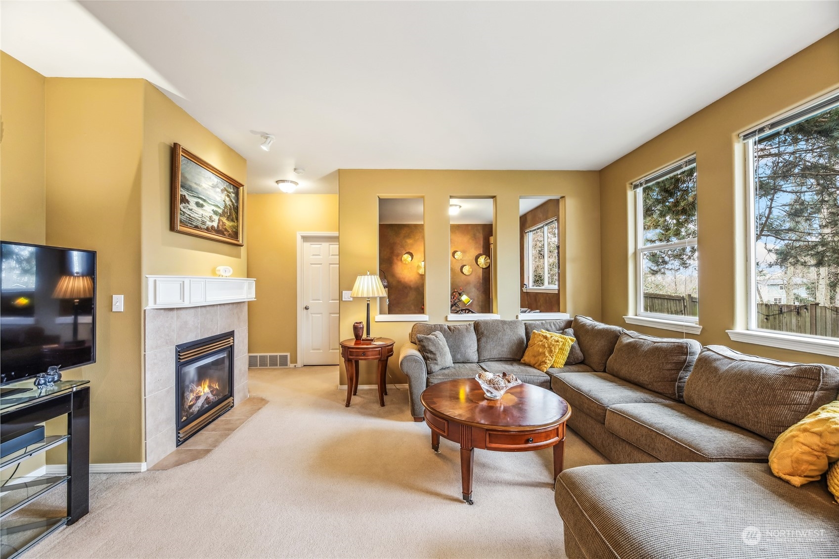 210 202nd Street Southeast Bothell, WA 98012 - Photo 10 of 33 a living room with furniture flat screen tv and a fireplace