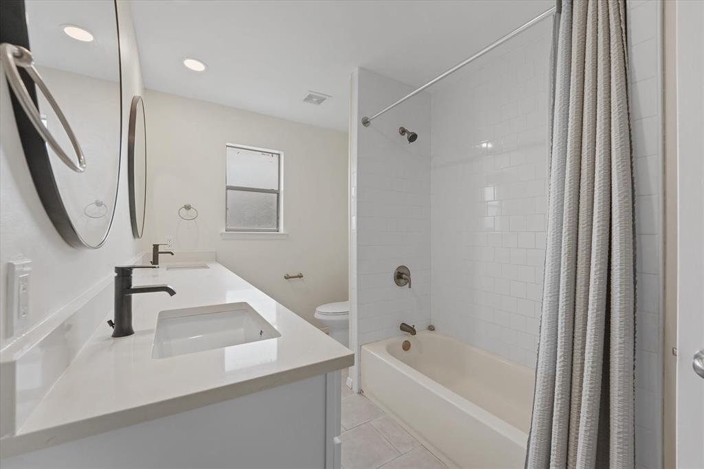 4007 Ridgebrook Drive Arlington, TX 76015 - Photo 17 of 18 Bathroom featuring a double vanity with integrated rectangular sinks, white quartz countertops, and matte black fixtures
