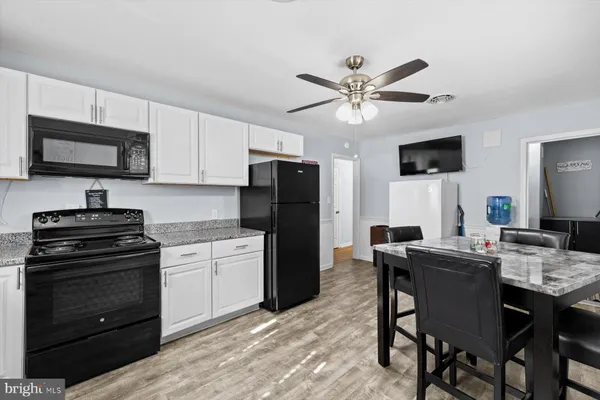 a kitchen with a stove a sink and a refrigerator