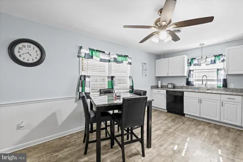a view of a dining room with furniture and a kitchen