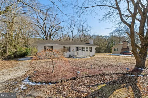 a view of a house with a yard covered with snow