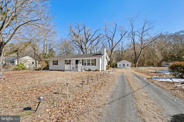 a view of a house with a yard covered in snow