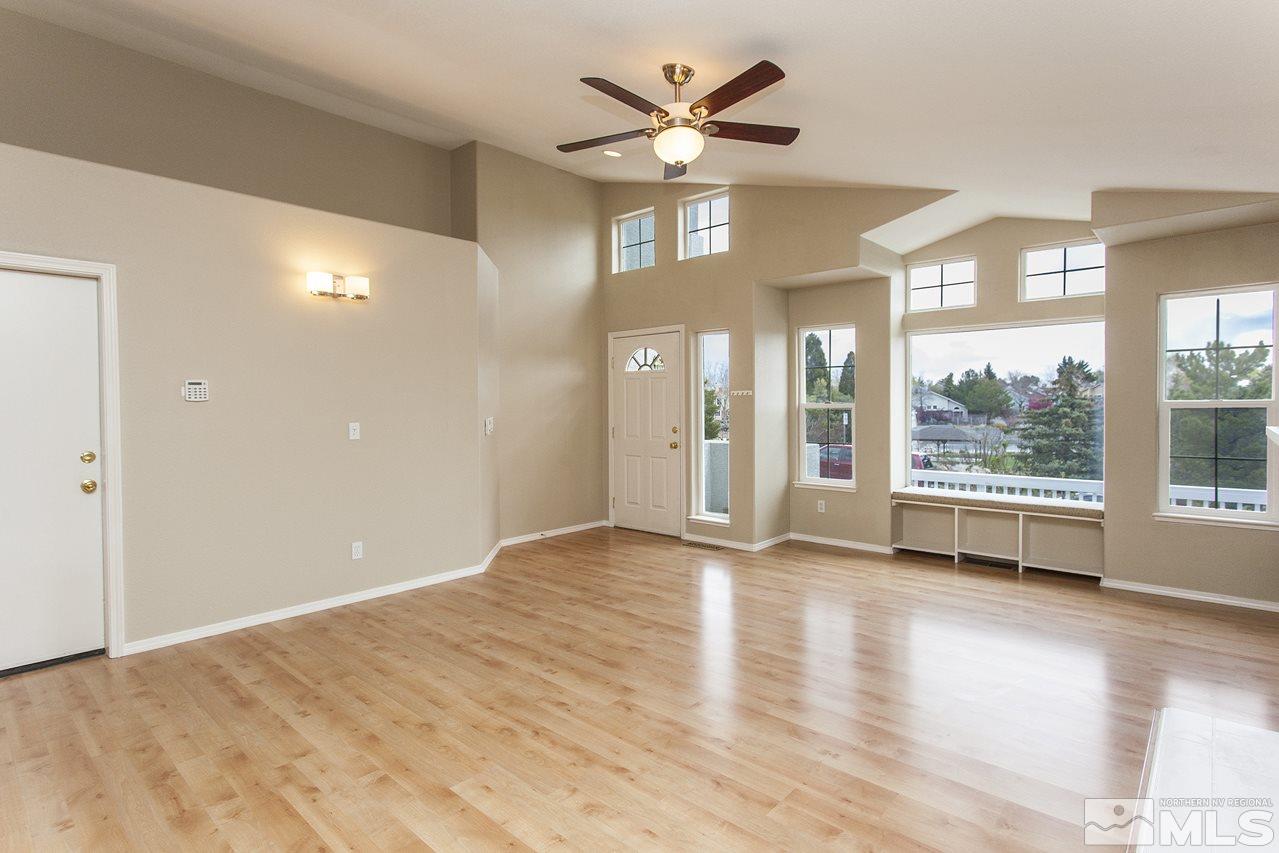 6020 Sunrise Meadows Loop Reno, NV 89519 - Photo 4 of 30 a view of an empty room with a window and wooden floor