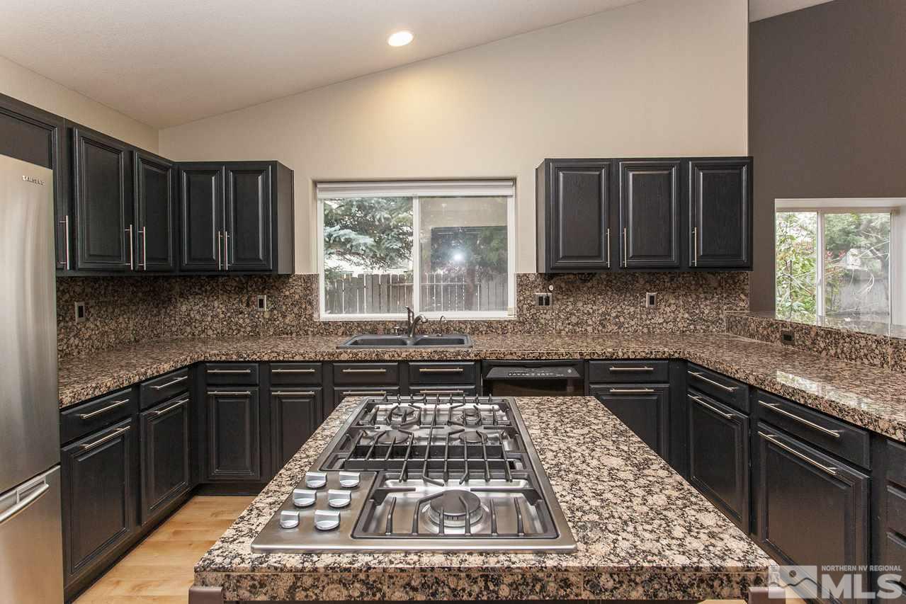 6020 Sunrise Meadows Loop Reno, NV 89519 - Photo 10 of 30 a kitchen with a stove a sink and a microwave