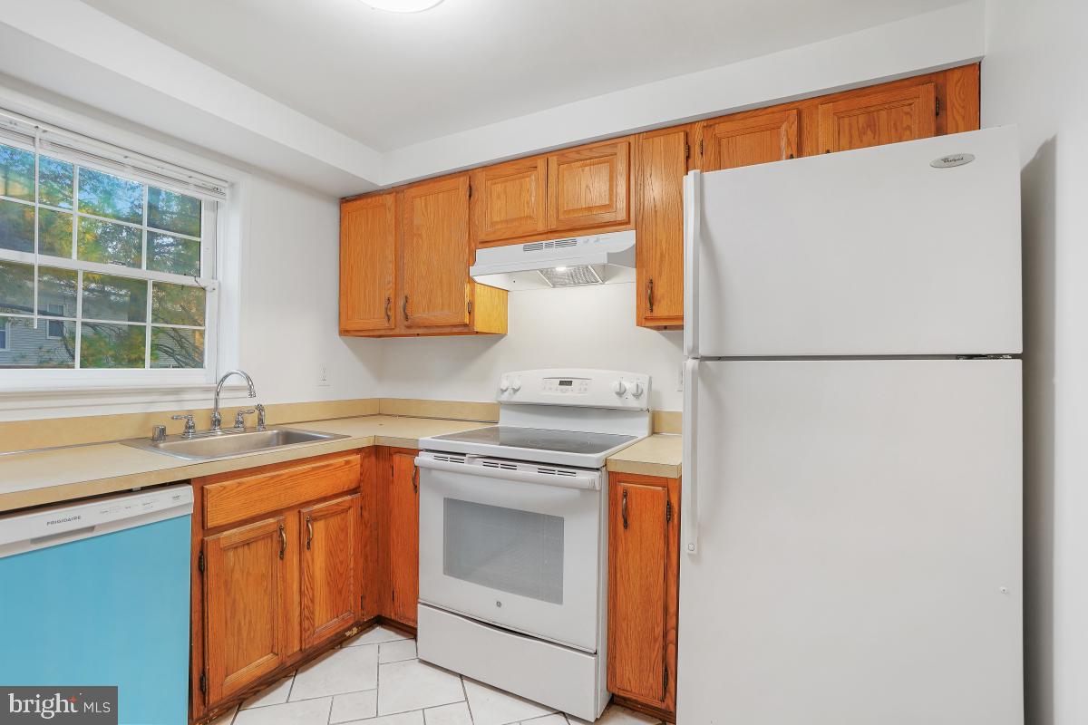 13221 Black Walnut Court Silver Spring, MD 20906 - Photo 12 of 30 a kitchen with a sink and a refrigerator