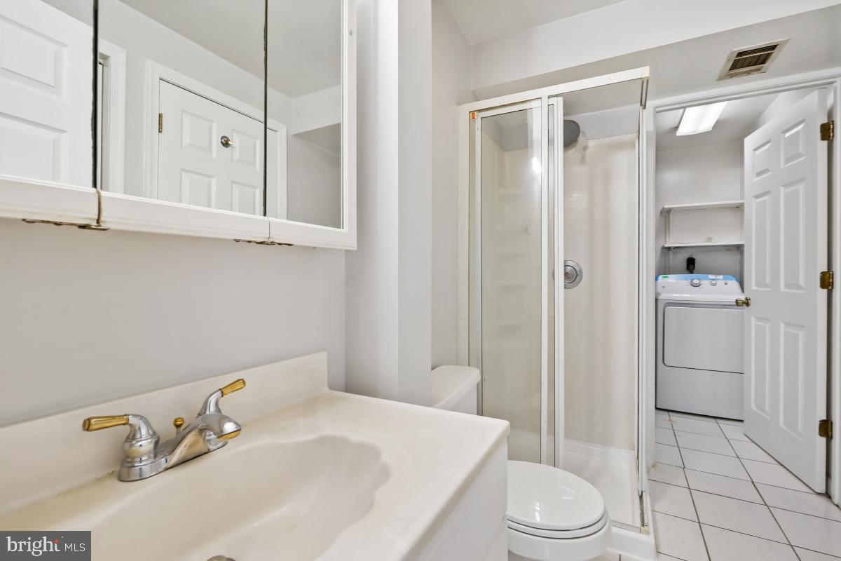13221 Black Walnut Court Silver Spring, MD 20906 - Photo 25 of 30 a bathroom with a sink a toilet and shower