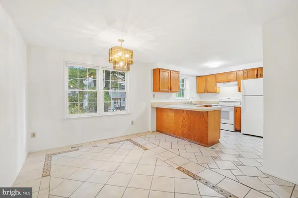 a view of kitchen with granite countertop cabinets and window