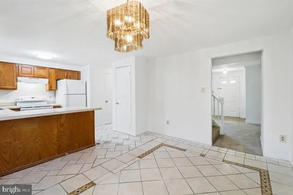 a kitchen with refrigerator cabinets and a window
