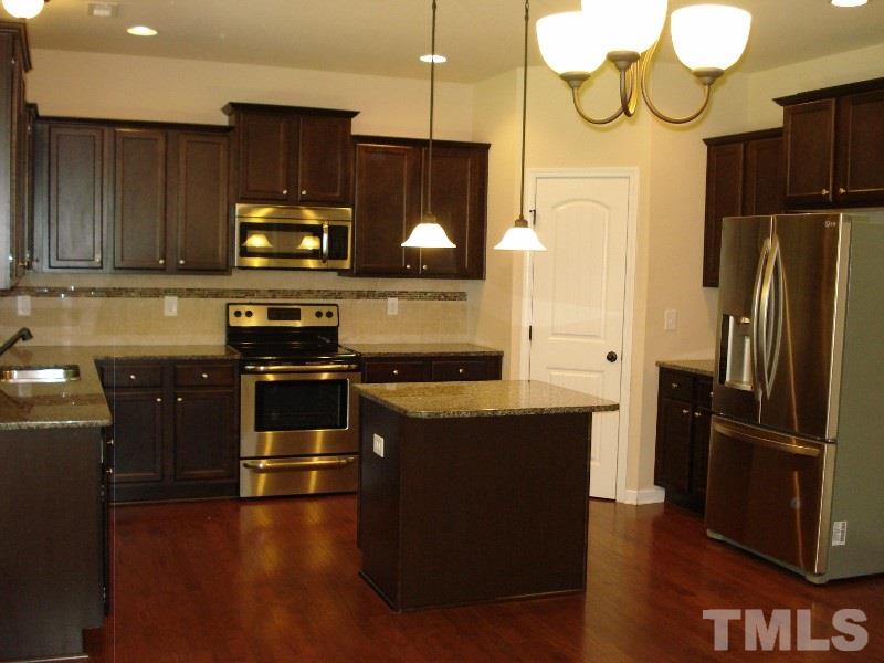 80 Germantown Road Cameron, NC 28326 - Photo 10 of 25 a kitchen with stainless steel appliances wooden cabinets and a wooden floor