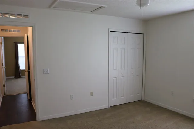 a view of an empty room with a mirror