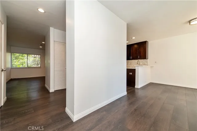 a view of a livingroom with wooden floor and a flat screen tv
