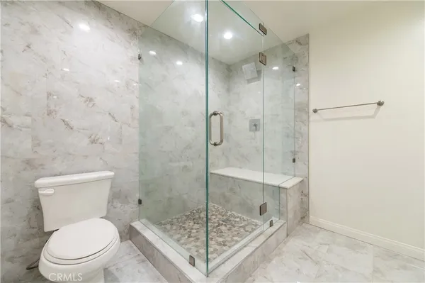a bathroom with a shower and toilet