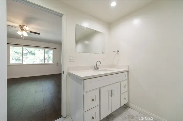 a bathroom with a double vanity sink a window and a mirror