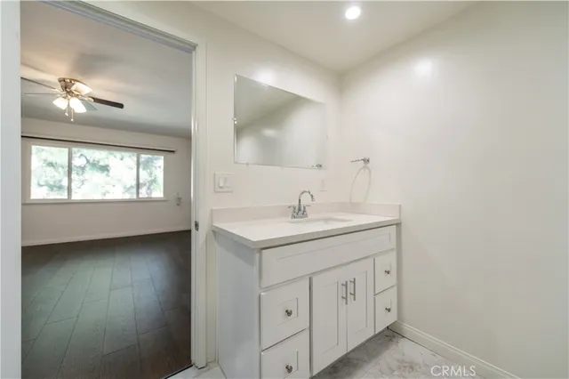 a bathroom with a double vanity sink a window and a mirror