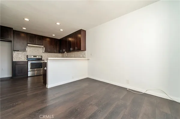 a view of kitchen with wooden floor and electronic appliances