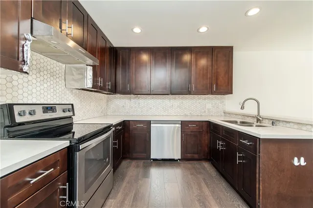 a kitchen with a sink cabinets and appliances