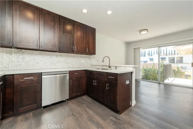 a kitchen with wooden cabinets and sink