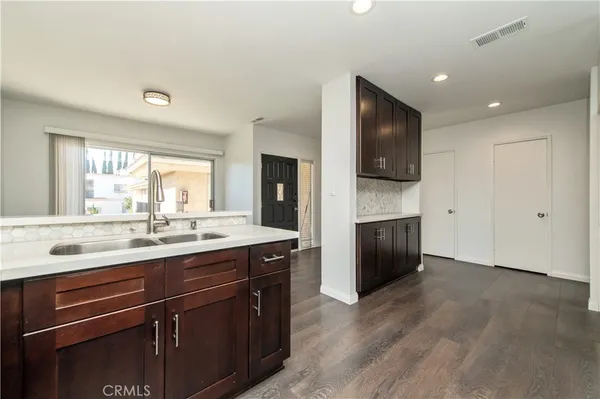 a kitchen with a sink and a stove top oven