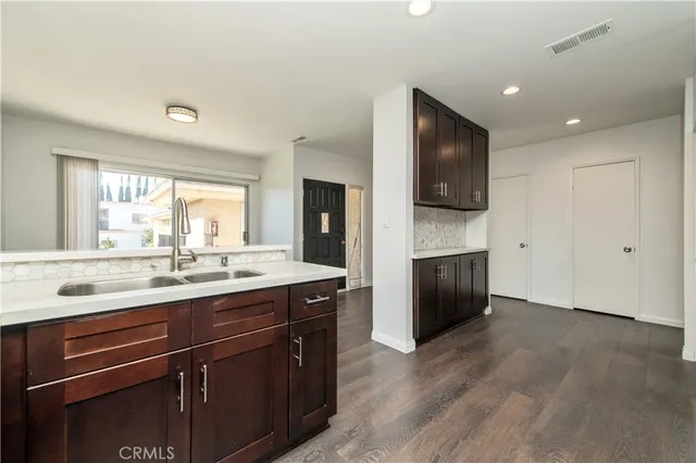 a kitchen with a sink and a stove top oven
