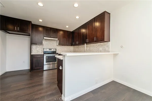 a kitchen with a refrigerator and a microwave