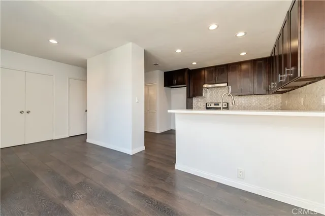 a kitchen with kitchen island stainless steel appliances a sink and refrigerator