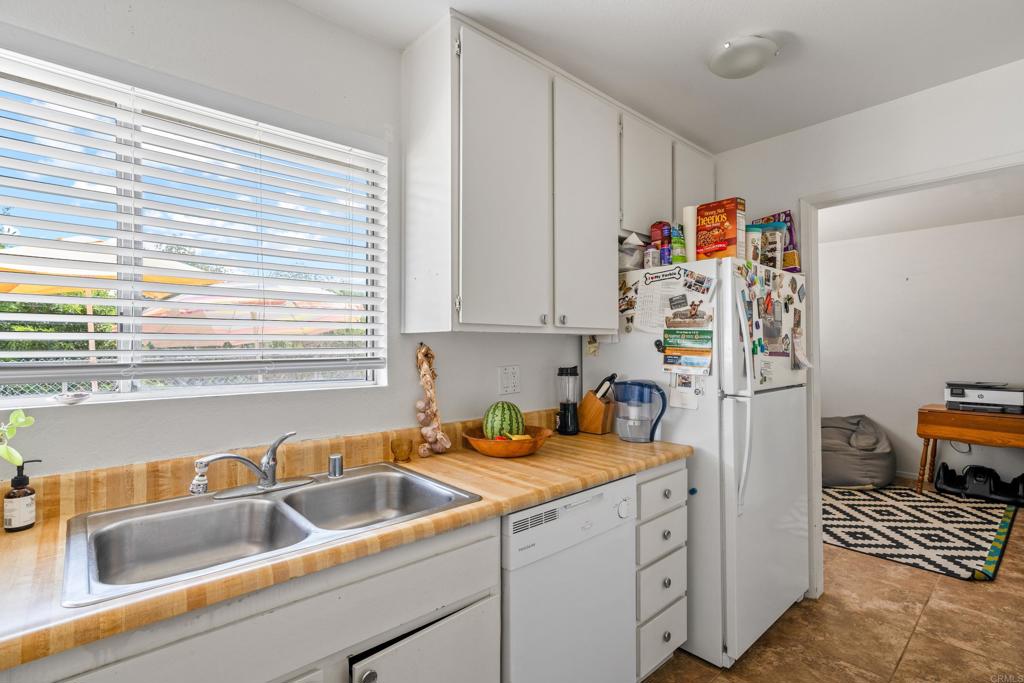 4533 Sunrise Oceanside, CA 92056 - Photo 11 of 24 a kitchen with a sink and a refrigerator