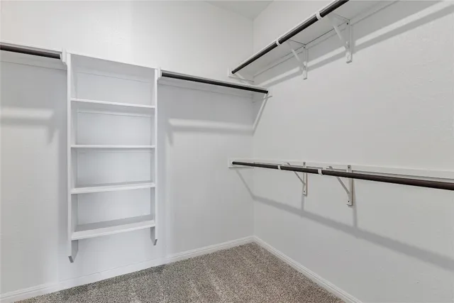 a spacious bathroom with a double vanity sink a mirror and a shower