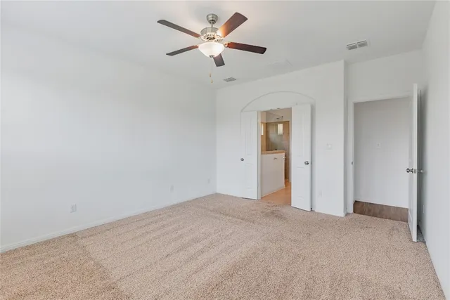 an empty room with windows and entrance