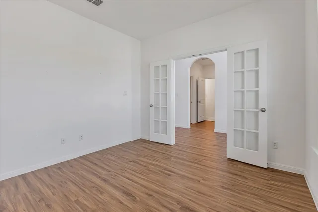 a view of a room with wooden floor and window