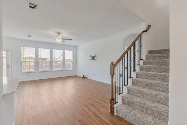 a view of kitchen and hall with wooden floor