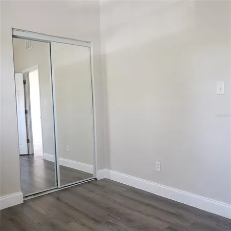 an empty room with wooden floor