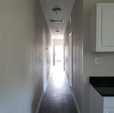 a view of hallway with wooden floor