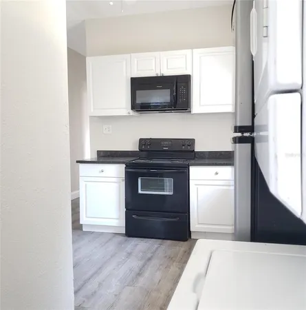 a kitchen with a sink and a stove top oven