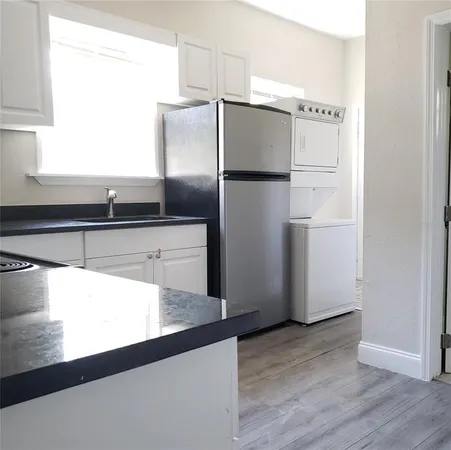 a kitchen with refrigerator and window