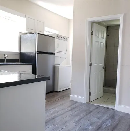a kitchen with stainless steel appliances granite countertop a refrigerator and a sink