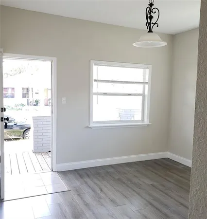 a view of a livingroom with wooden floor and a window