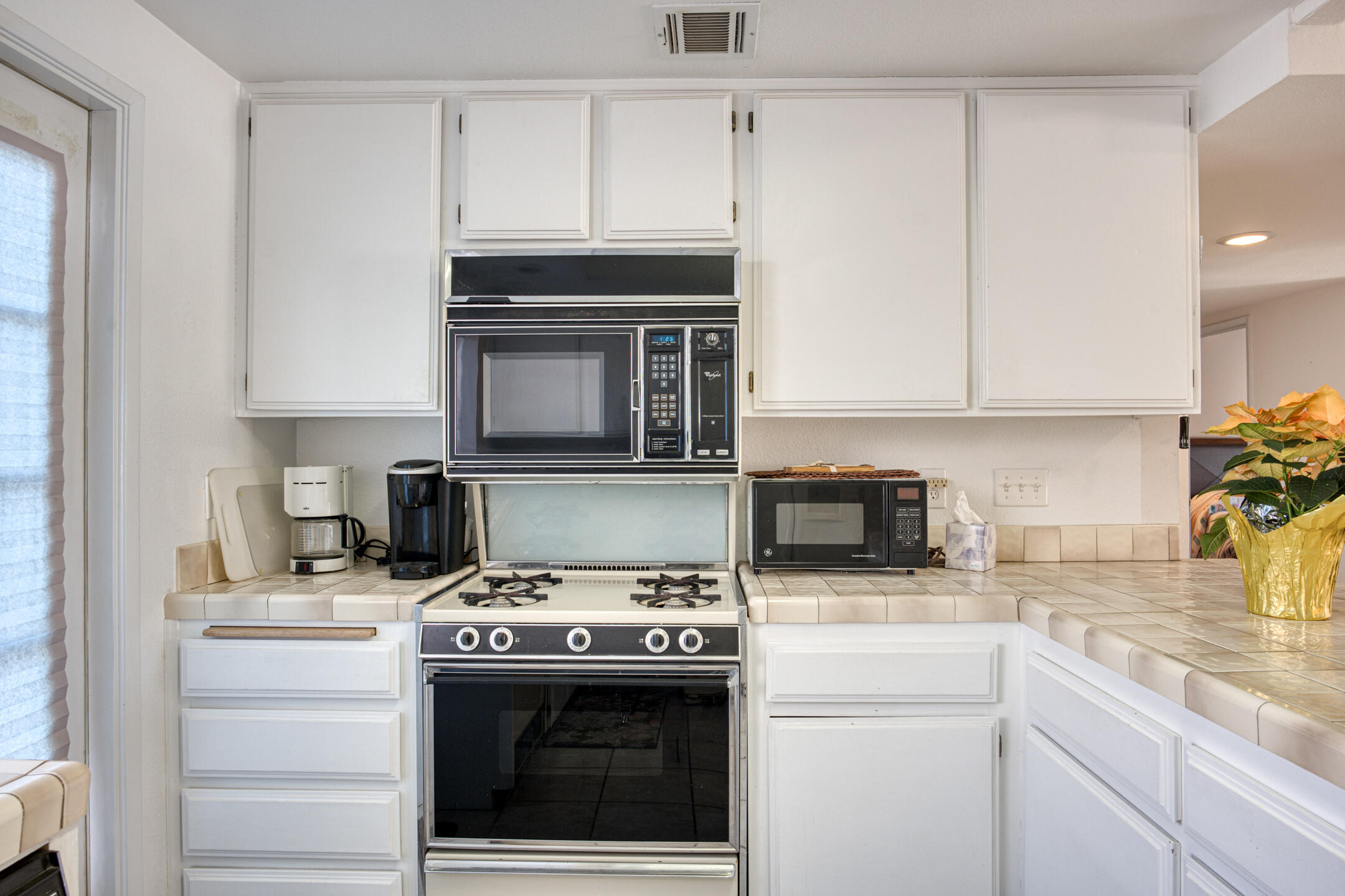 49211 Douglas Street Indio, CA 92201 - Photo 12 of 44 a kitchen with a stove and a microwave