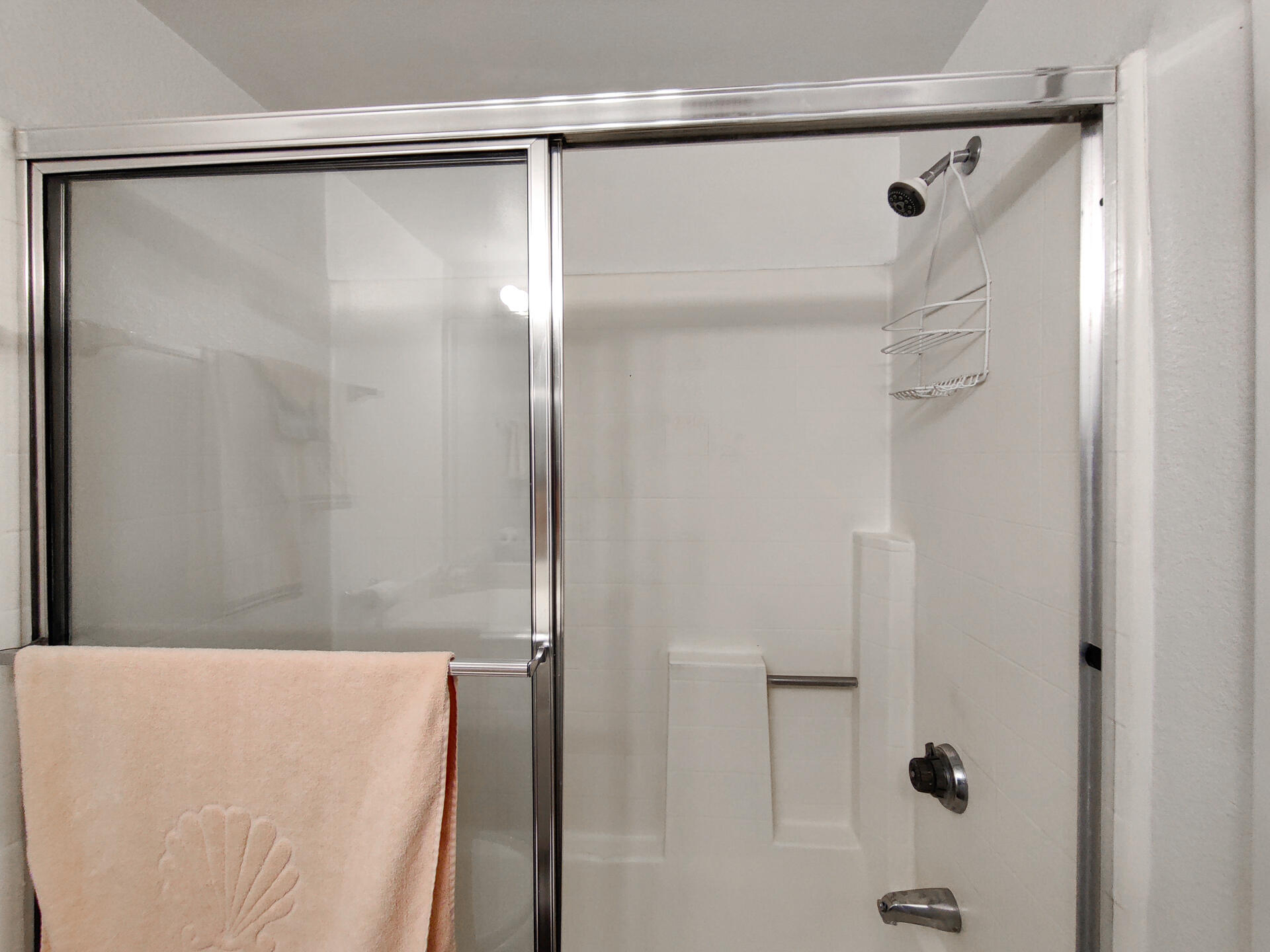 49211 Douglas Street Indio, CA 92201 - Photo 24 of 44 a bathroom with a shower and a glass door