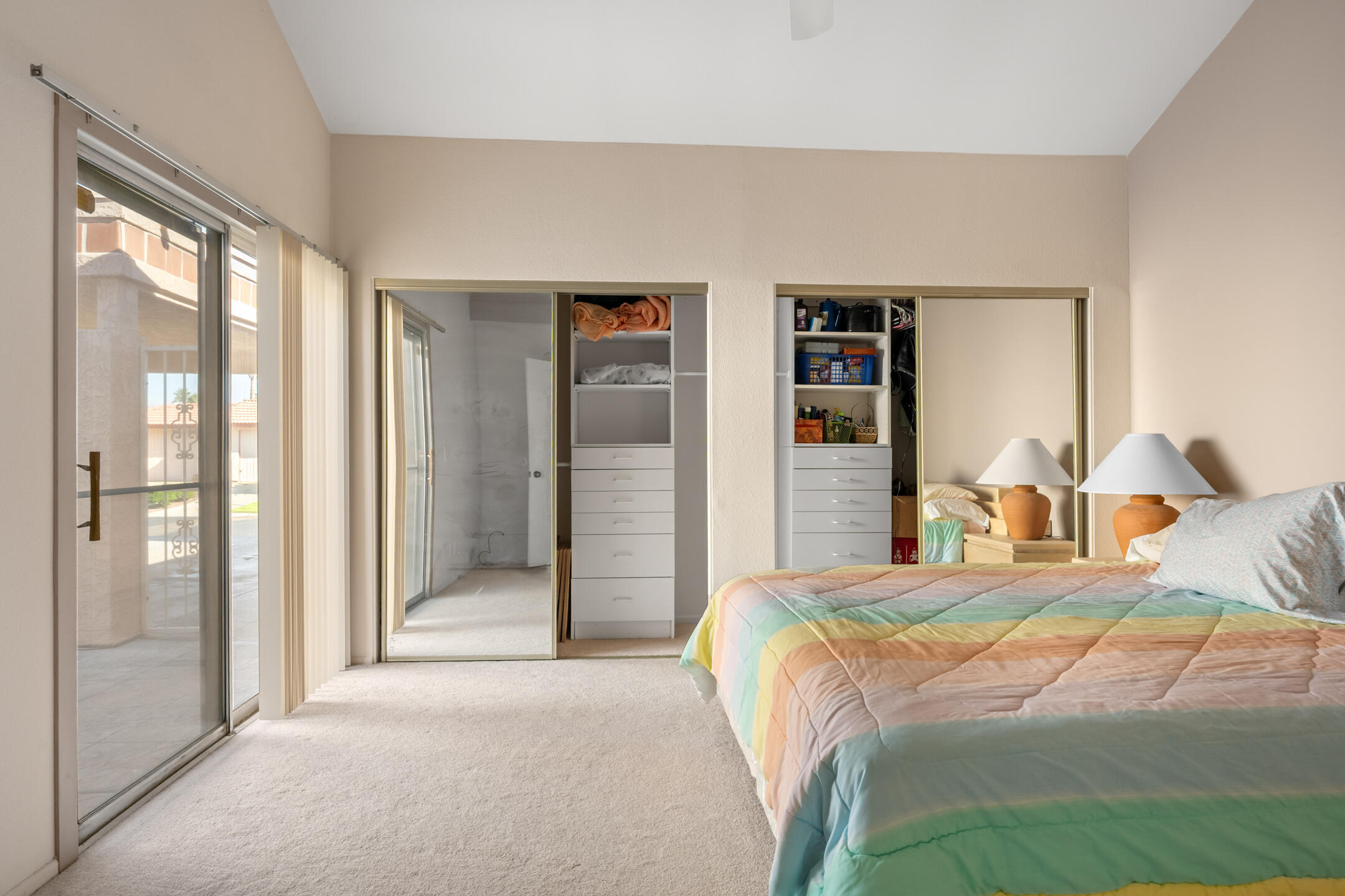 49211 Douglas Street Indio, CA 92201 - Photo 25 of 44 a bedroom with a large bed and a large closet