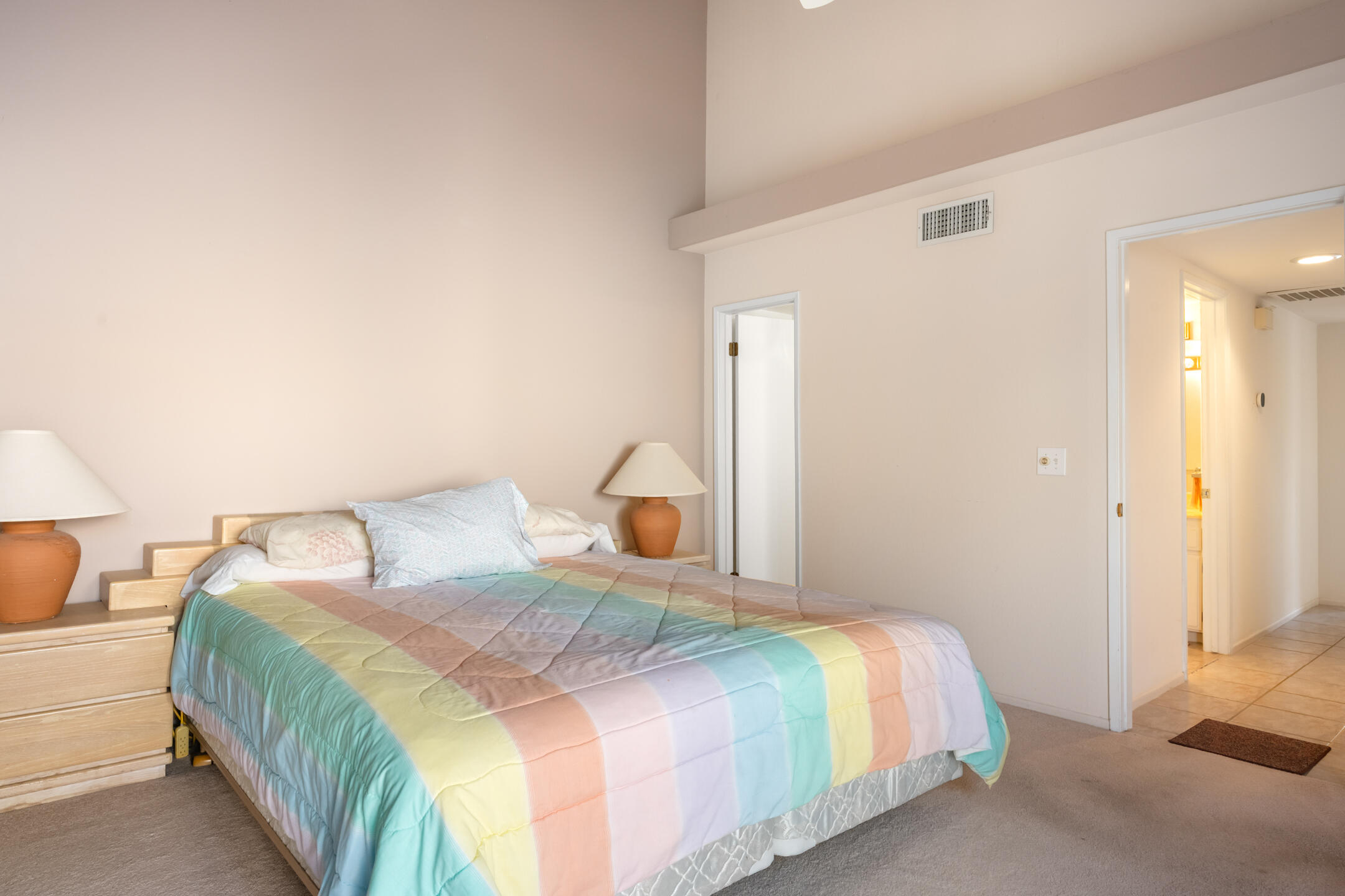 49211 Douglas Street Indio, CA 92201 - Photo 26 of 44 a bedroom with a bed and a lamp